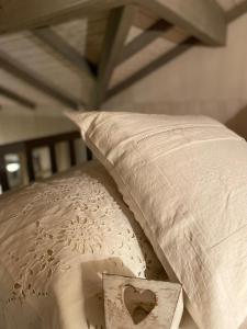 a pillow sitting on a bed with a pillowcase on it at Jolie Tiny House sous les Grands Arbres in Cholet