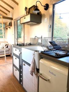 a kitchen with a sink and a counter top at Jolie Tiny House sous les Grands Arbres in Cholet