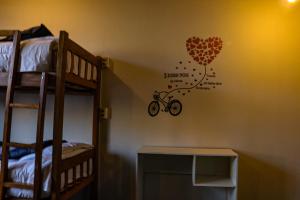 a room with a wall with a bike with a heart at Lobo Hostel La Paz in La Paz