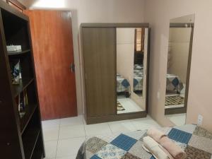 ein Schlafzimmer mit einem Bett und einem großen Spiegel in der Unterkunft Conforto e comodidade em Santa Maria in Santa Maria