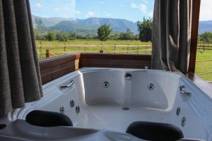a white bath tub sitting in a room with a window at Mirador da Montanha in Praia Grande