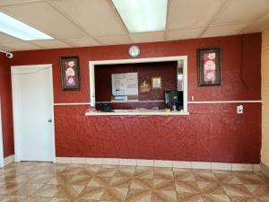 an office with a red wall with a counter at Executive Inn in Mena
