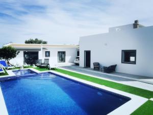 a swimming pool in the backyard of a house at Casas Caiado Two Houses with swimming POOL in Faro