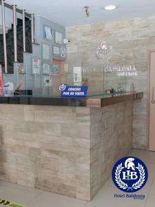 a restaurant counter with a sign for a hotel restaurant at Hotel Babilonia Boutique in Cúcuta