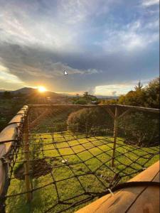 a kite flying in the sky over a field at Alto Paraíso Glamping Carmen de Viboral in Rionegro