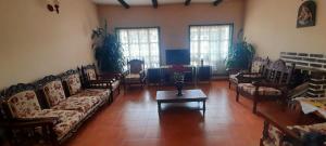 a living room with couches and a coffee table at Hotel Casa San Rafael in Villa de Leyva