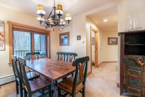 a dining room with a wooden table and chairs at Red Hawk Lodge by Summit County Mountain Retreats in Keystone