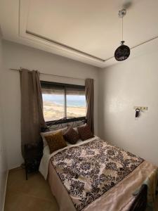 a bedroom with a large bed with a window at House of banana beach aourir in Aourir