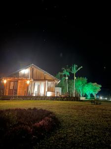 a house is lit up at night with green lights at Mirador da Montanha in Praia Grande