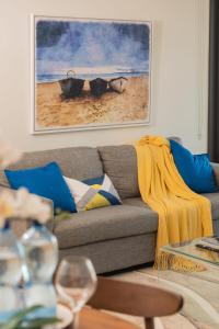 a living room with a couch with a painting on the wall at Prime Location Compact 1BD Apartment at Southbank in Brisbane