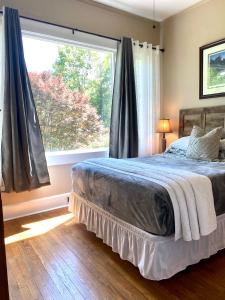 a bedroom with a bed and a large window at Grafton Lodge in Lake Lure