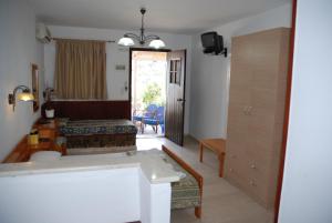 a living room with a bed and a bathroom at Villa Italiana in Agios Nikolaos