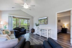 a living room with a couch and a ceiling fan at Beach Place at True Blue - Close to the beach! in Pawleys Island