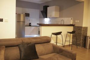 a living room with a couch and a kitchen at The Crib in Cayenne