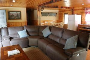 a living room with a brown leather couch and a table at Lake View Lodge in Lee Vining