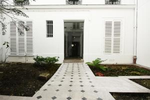 a white house with a black and white tile walkway at Bridgestreet Champs-Elysées in Paris