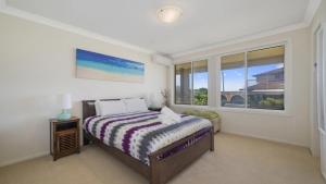 a bedroom with a bed and a window at Beach Break - Umina Beach Water Views in Umina