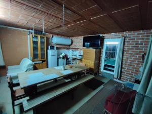 a kitchen with a wooden table and a brick wall at Apartment & Rooms Constantí in Constantí