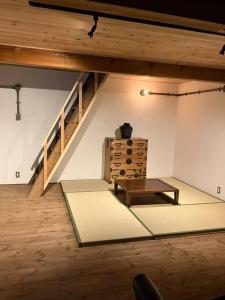 a room with a table and a stair case at １日１組様限定「レジデンス」 in Nagano