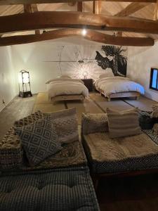 a room with three beds with pillows on the floor at １日１組様限定「レジデンス」 in Nagano