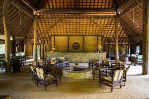 a large room with tables and chairs and a fountain at Tiger Tops Karnali Lodge in Bardiyā