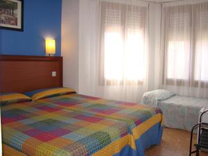 Postel nebo postele na pokoji v ubytování Hostal Platja