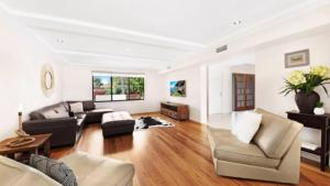 a living room with a couch and a table at Tranquil Lagoon - Waterfront Luxury in Daleys Point