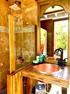a bathroom with a sink and a mirror at Sedona Camp Tiny House in Sedona