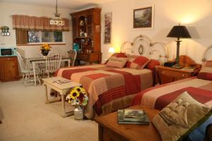 a bedroom with two beds and a kitchen with a table at Crystal River Lullaby B&B in Crystal River