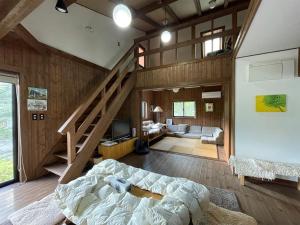 a bedroom with a staircase and a living room at Villa Aone - Vacation STAY 82324v in Kawasaki