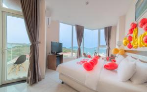 a hotel room with a bed with flowers on it at CLIFF HOUSE managed by DHG in Nha Trang