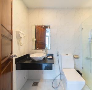 a bathroom with a sink and a toilet and a mirror at CLIFF HOUSE managed by DHG in Nha Trang