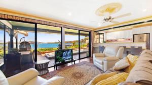 a living room with a view of the ocean at North View - St Huberts in Daleys Point