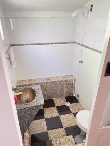 a bathroom with a toilet and a sink at Sítio do Vô Pisco in Camboriú +14 photos