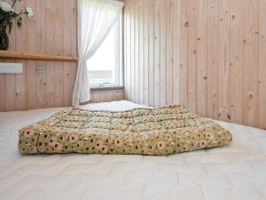 a bedroom with a large bed in front of a window at Holiday home Aabenraa LXX in Aabenraa