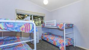 Postel nebo postele na pokoji v ubytování Endless Summers - Pearl Beach + 6 fotografií