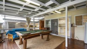 a living room with a pool table in it at Castaway - Ettalong Beach in Ettalong Beach