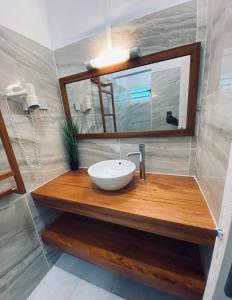 a bathroom with a sink and a mirror at HAMACA 107 KAWANN CENTER in Grand-Bourg