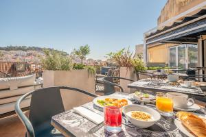 a table with breakfast food on a balcony at The ART INN Lisbon in Lisbon