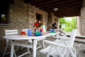 a white table and chairs on a patio at B&B Costalta in Compiano