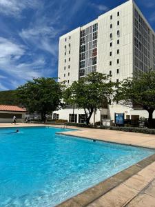 a large swimming pool in front of a building at Bayfront Villa & Apartment in Portmore