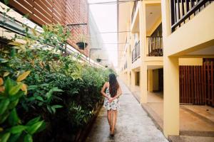 a woman walking down a hallway in a building at Kata Silver Sand in Kata Beach