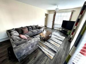 a living room with a couch and a table at Fantastic Holiday Home in Laindon