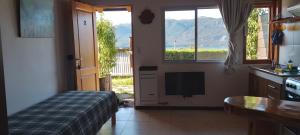 a kitchen with a bed and a television in a room at La Fortaleza Deptos in Villa Traful
