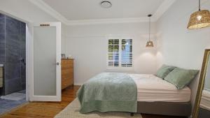 a bedroom with a bed and a walk in shower at Bayview Escape Woy Woy Bay in Woy Woy