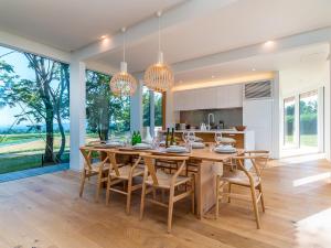 a kitchen and dining room with a wooden table and chairs at Yukihyo by H2 Life in Niseko