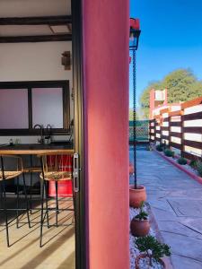 an open door to a patio with a table and chairs at WAYTAY in Cafayate