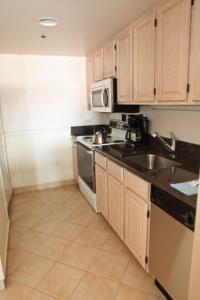 a kitchen with a sink and a stove at Watson's Regency Suites in Ocean City