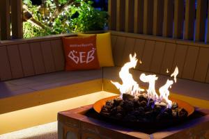 a fire pit in the middle of a patio at BEB5 Okinawa Seragaki by Hoshino Resorts in Onna