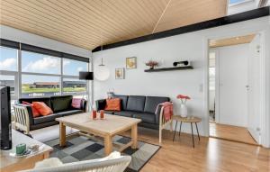a living room with a couch and a table at Three-Bedroom Holiday Home Nordborg With A Room Hot Tub 01 in Nordborg